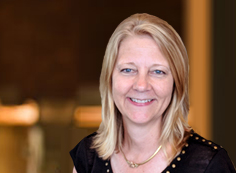 Laura Johnson A woman with blonde hair wearing black is smiling.