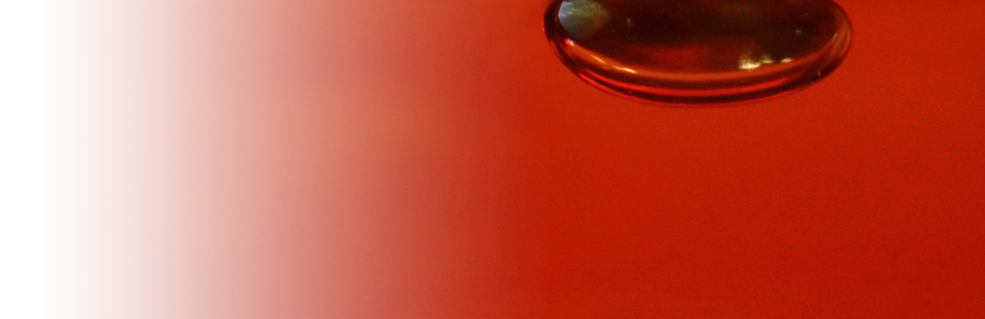 A red table with a glass of water on it